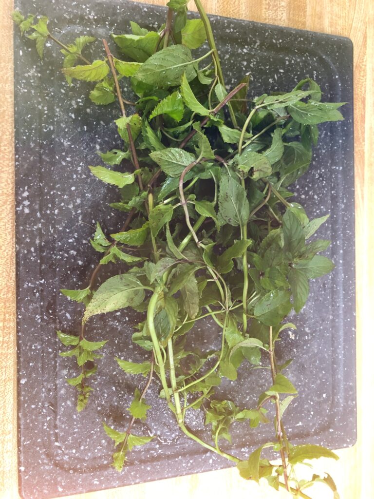 cut mint on a cutting board on the counter