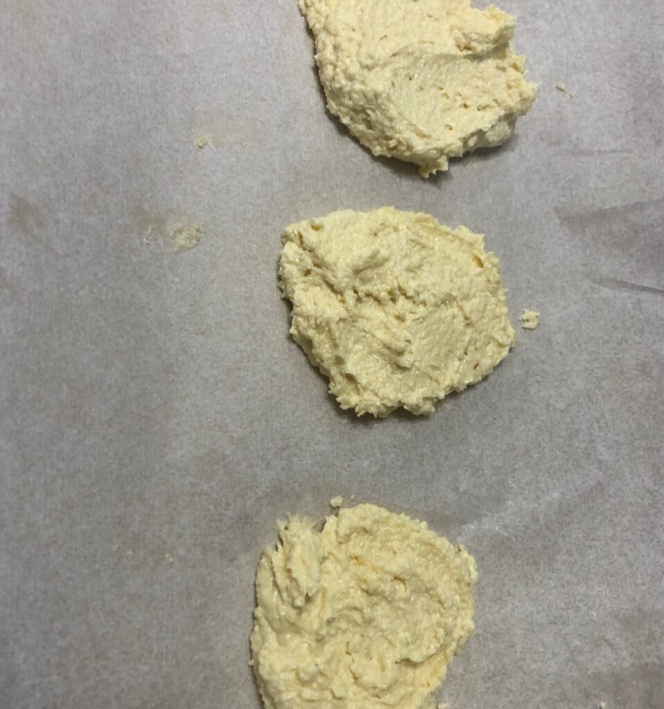 sugar free thyme cookies ready to go in oven on parchment paper and a cookie sheet