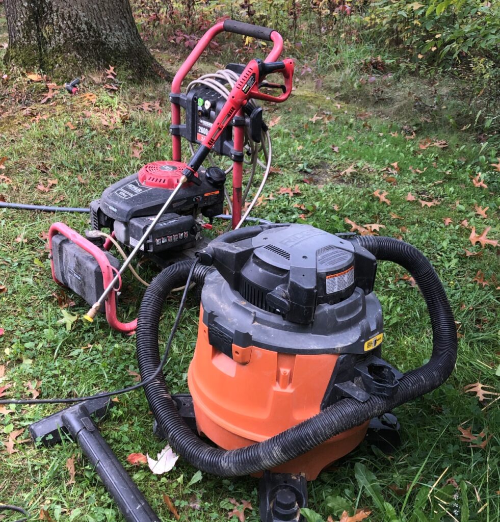 shop vac and power washer on green grass