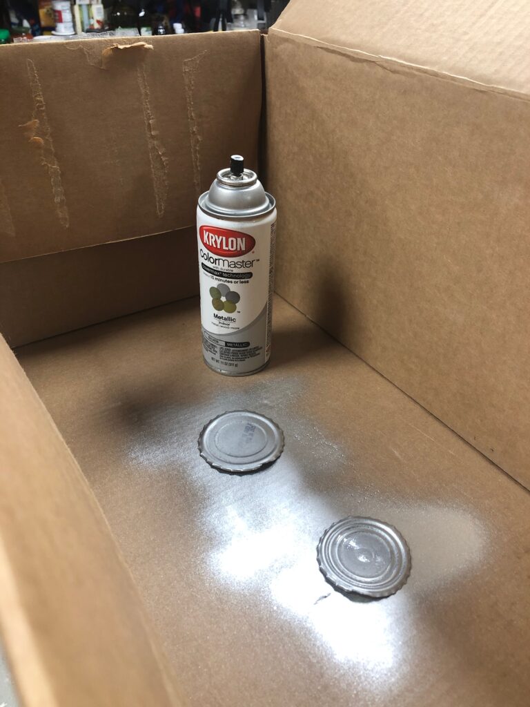 spray paint with lid off in box painted aluminum can lids in silver